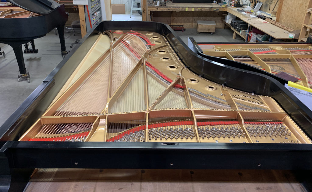 Steinway Concert Grand with new soundboard, strings, pins and pin block.